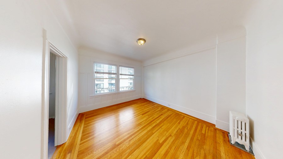 A room with wooden floors and a window.